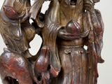 a statue of a man holding a bird and a bird on his arm