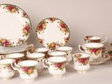 many different types of tea cups and saucers on the table
