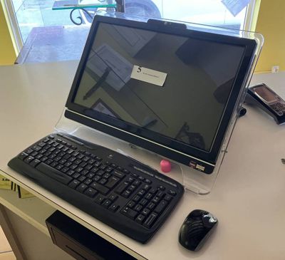 a laptop computer sitting on a desk with a keyboard and mouse