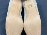 a pair of women ' s shoes on a blue surface