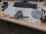 a desk with a computer, keyboard, mouse and other items on it