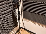 a microphone and a tripod stand in the corner of a room