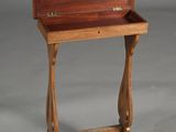 a small wooden table with a drawer on it