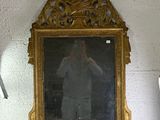 a mirror that is sitting on a shelf in a room