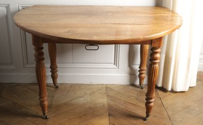 a small table with a wooden top on a hard wood floor