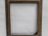 an old picture frame sitting on top of a white surface