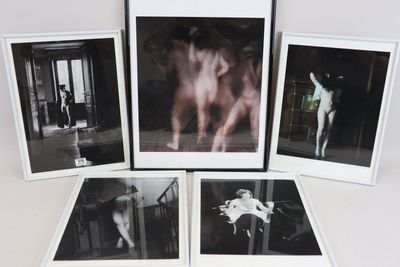 four black and white photographs of a nude woman in a living room