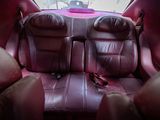 the back seats of a car are covered in pink leather