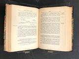 an open book on a table with a black background