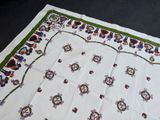 a white table cloth with a green border on it
