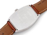 a close up of a wrist watch with a brown leather strap