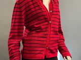 a mannequin wearing a red and black striped cardigan