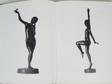 an open book with a black and white photo of a statue