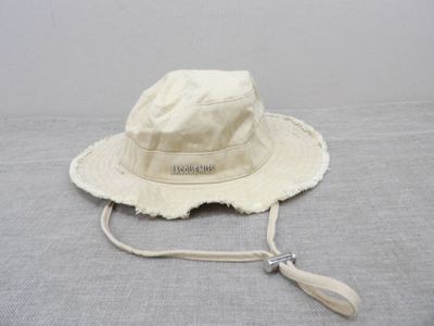the hat is white and has a tassel around the brimle