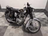 a motorcycle that is parked on a checkered floor