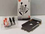 a box of ear buds and a charger on a table