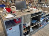 a desk with a computer on top of it in a store