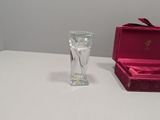 a small glass vase sitting on a table next to a pink box