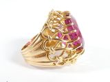 an image of a gold ring with a pink stone in it