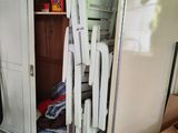 a closet full of clothes and a chair in the room
