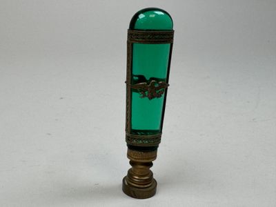 a green glass bottle with a horse design on it
