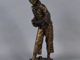 bronze statue of a woman holding a basket of flowers on a base