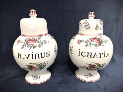 pair of ceramic urns with floral designs on them on a black background