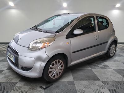 a picture of a small silver car on a checkered floor