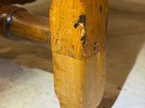 a close up view of a wooden table with a wooden leg