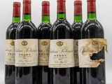 six bottles of red wine are lined up in a row