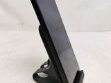 a cell phone that is on a stand on the table