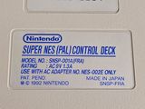 a nintendo super nes pad control deck on display