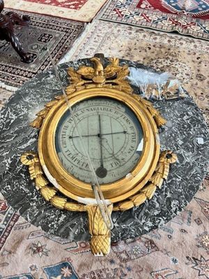 a clock sitting on a rug on the floor