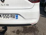 a close up of a white car parked in a parking lot