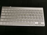 a computer keyboard and a mouse on a table