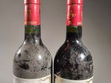 two bottles of wine sitting next to each other on a table