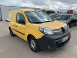 the yellow van is parked in a parking lot with other cars