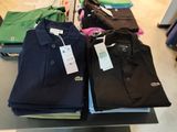 a lot of shirts that are on display in a store