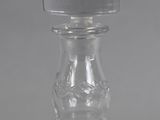 a clear glass bottle with a stopper on top of it