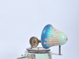 a blue and white music box with a horn on it