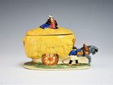 a figurine of a horse drawn carriage with a man and a woman on it