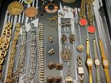 many different types of watches and bracelets in a case