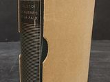 an old book sitting in a cardboard box on a table
