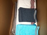 a cardboard box filled with towels and a pair of socks
