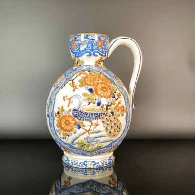 a blue and white vase sitting on a black table