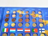 a lot of different coins in a blue box