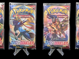 three packs of pokemon trading cards on a black background