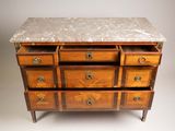 an antique chest of drawers with marble top
