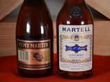 two bottles of wine sitting on a table next to each other