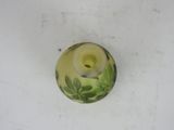 a small vase with a green and white design on it